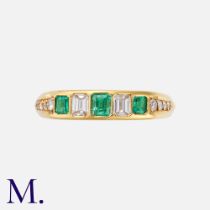 An Emerald & Diamond Ring in 18K yellow gold, set with three emerald cut emeralds, two emerald cut