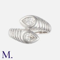 BULGARI. A Diamond Bypass Ring in 18K white gold, set with two pear cut diamonds of approximately