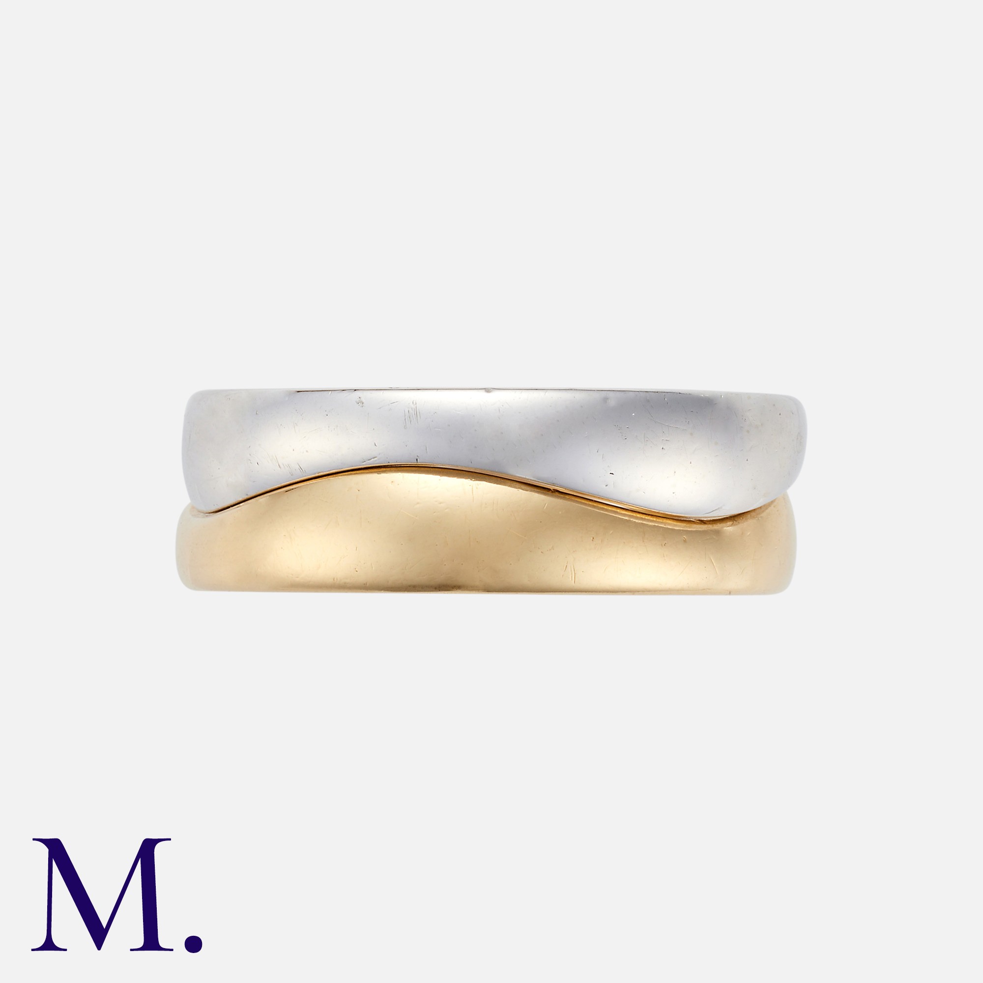 CARTIER. A Pair of Gold Wave Bands in 18K white and yellow gold, of separate interlocking bands.