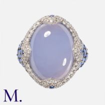 ASPREY. A Chalcedony, Sapphire And Diamond Ring in 18k white gold, set with a large cabochon