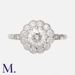 A Diamond Cluster Ring in platinum, the principal claw set round brilliant cut diamond of