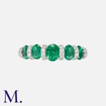 An Emerald & Diamond Ring in 18K white gold, set with five oval cut emeralds and round cut