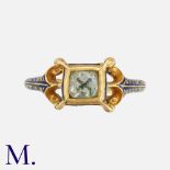 An Antique Paste And Enamel Ring in yellow gold, the ornate band decorated in dark blue enamel,