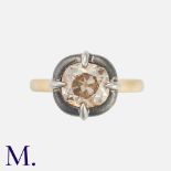 A Fancy Colour Old Cut Diamond Solitaire Ring in 18k yellow gold, set with a principal fancy