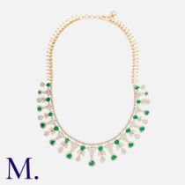 An Emerald & Diamond Fringe Necklace in 14k yellow gold, comprising a diamond set line suspendsing a