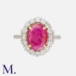 A Ruby & Diamond Cluster Ring in 18k white gold, set with a principal oval cut ruby of approximately