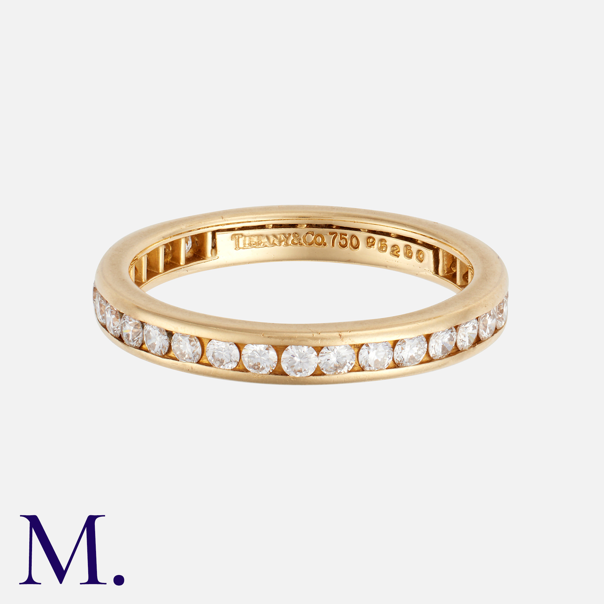 TIFFANY & CO. A Diamond Eternity Ring in 18K yellow gold, set with round brilliant diamonds weighing