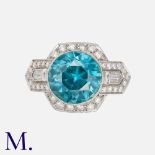 A Zircon And Diamond Ring in platinum, set with a principal round cut blue zircon of approximately