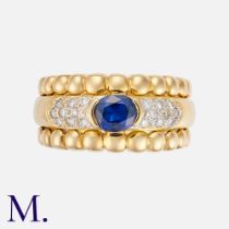 A Sapphire & Diamond Ring in 18k yellow gold, set with a principal oval cut sapphire of