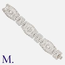 An Art Deco Diamond Bracelet in platinum, set with round cut and baguette diamonds, the three