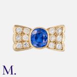 A Sapphire & Diamond Retro Ring in 18K yellow gold, set with an oval-cut sapphire accompanied by a