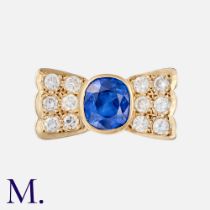 A Sapphire & Diamond Retro Ring in 18K yellow gold, set with an oval-cut sapphire accompanied by a