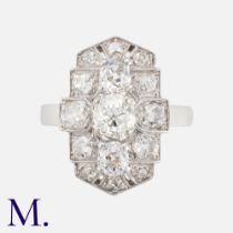 An Edwardian Diamond Ring in platinum, designed in plaque form, the principal diamond of