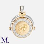 BULGARI. A Spinning Zodiac Pendant in 18k yellow gold and steel, the articulated spinning pendant on