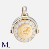 BULGARI. A Spinning Zodiac Pendant in 18k yellow gold and steel, the articulated spinning pendant on