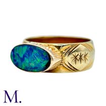 An Opal Doublet Ring in 9k yellow gold, the engraved ring set with an opal doublet. Hallmarked for 9