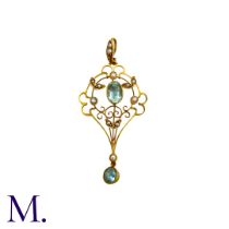 An Aquamarine And Pearl Pendant in 15k yellow gold , the open work foliate and scrolling form set