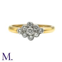 A Diamond Cluster Ring inn 18 yellow gold, set with a cluster of nine round cut diamonds. Stamped