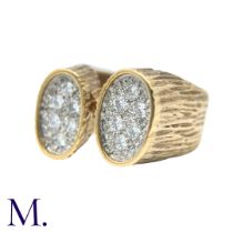 A Diamond Ring in yellow gold, the textured form with two oval plaques set with round cut