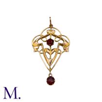 A Red Stone Pendant in 9k yellow gold, the open work scrolling form set with a round red stone,