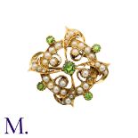 A Peridot And Pearl Brooch in 15k yellow gold, the circular form set with pearls and peridot with
