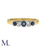 A Sapphire And Diamond Five Stone Ring in 18k yellow gold, set with three round cut sapphires and