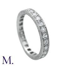 A Diamond Eternity Ring with carved sides set with round cut diamonds weighing approximately 0.80ct.