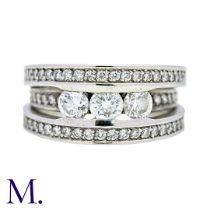 A Diamond Ring in 18k white gold, set with three principal round cut diamonds, set to three pavé set