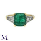 An Emerald And Diamond Ring in 18k yellow gold, set with a principal step cut emerald of