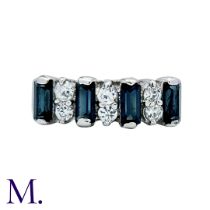 A Sapphire And White Stone Ring in white gold, set with step cut sapphires and round cut white