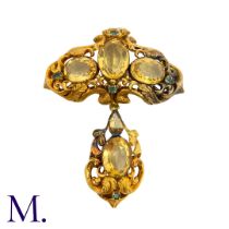 A Citrine And Emerald Brooch in yellow gold, the ornate scrolling body set with oval cut citrine and