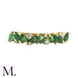 An Emerald And Diamond Ring in 18k yellow gold, set with marquise cut emeralds and punctuated with