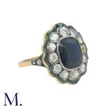 A Sapphire and Diamond Cluster Ring in 18K yellow gold with a large oval-cut sapphire of