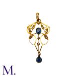 A Sapphire And Pearl Pendant in 15k yellow gold, the open work foliate and scrolling form set with a