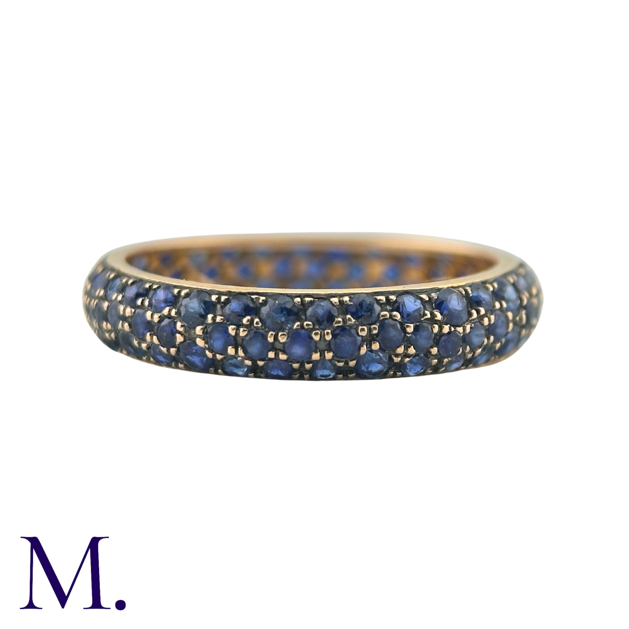 A Sapphire Eternity Ring in 18K yellow gold, set with three rows of round cut sapphires. Size: N