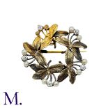 A Pearl And Diamond Brooch Pendant in yellow gold, the circular, foliate wreath form set with