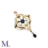 A Sapphire Pendant in yellow gold, the openwork scrolling and foliate motif set with a round cut