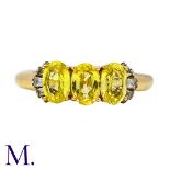 A Yellow Sapphire And Diamond Ring in 18k yellow gold, set with three principal oval cut yellow