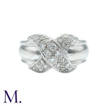 A Diamond Ring in 18k white gold, with a diamond set cross motif to a wide band. Stamped 750 for