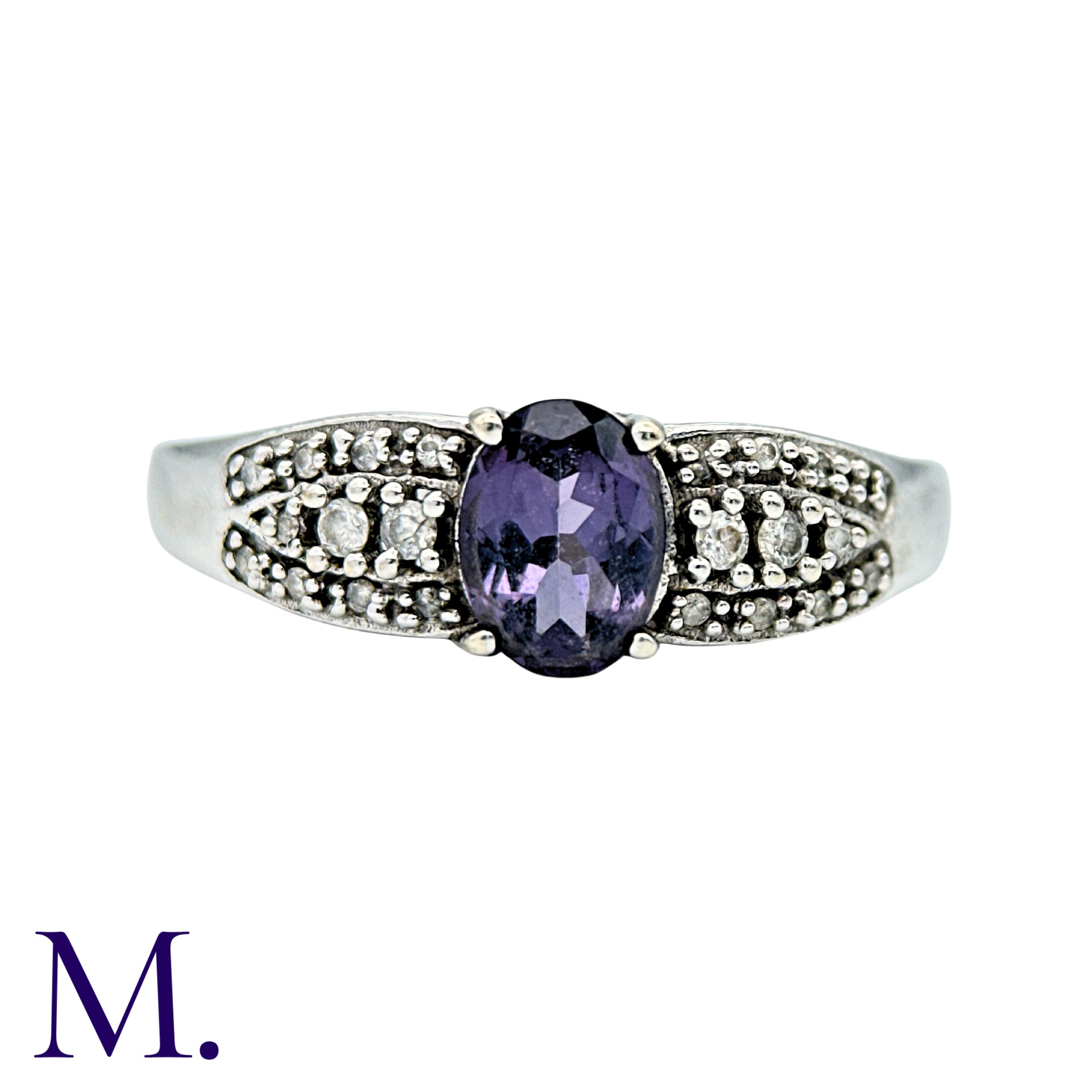A Purple Sapphire And Diamond Ring in 9k white gold, set with an oval cut purple sapphire with