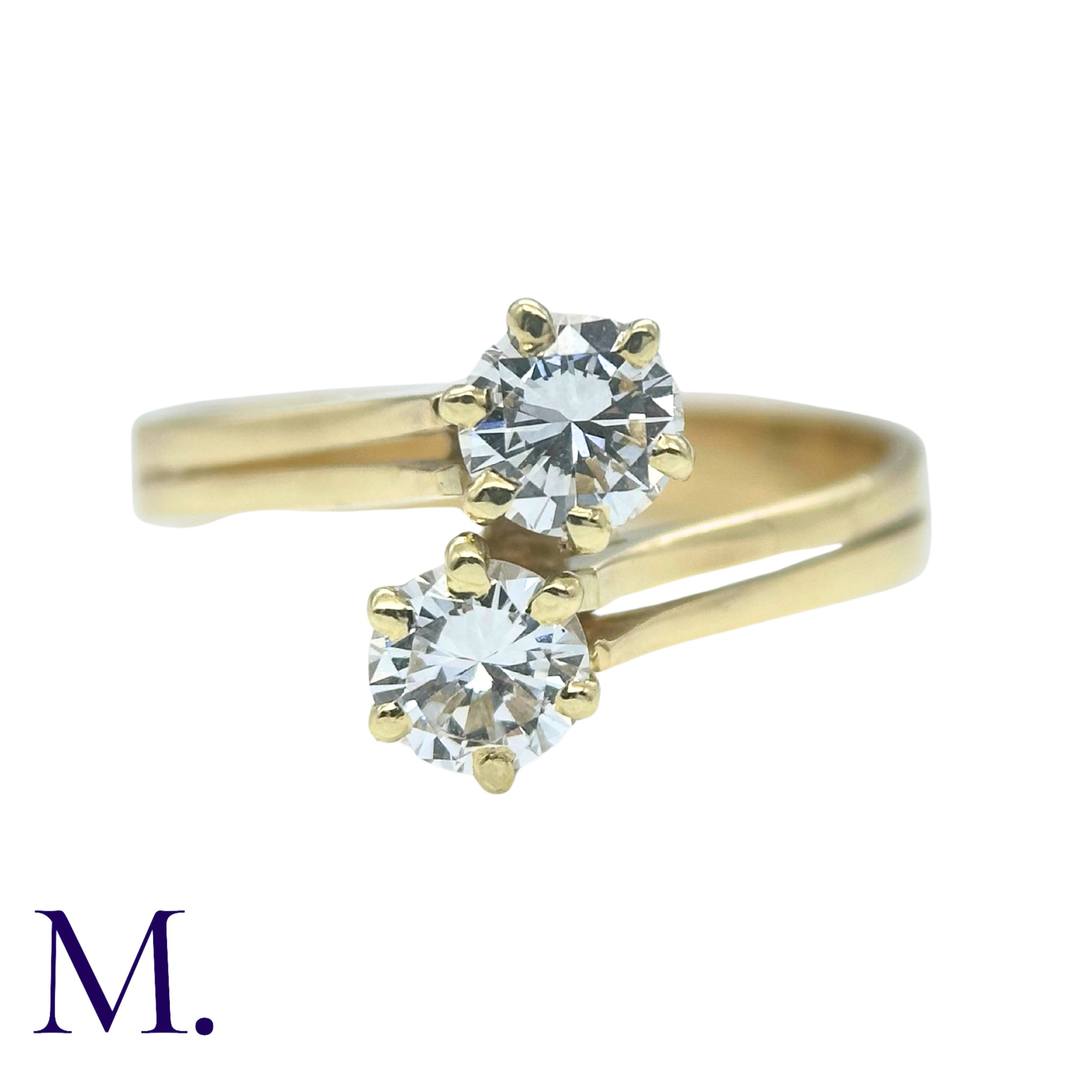 A Diamond 2-Stone Crossover Ring in 18K yellow gold, set with two round cut diamonds weighing