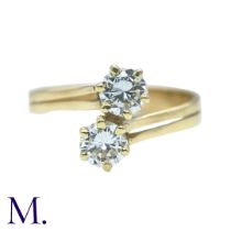 A Diamond 2-Stone Crossover Ring in 18K yellow gold, set with two round cut diamonds weighing