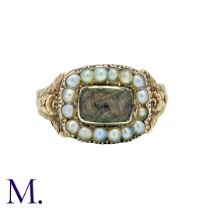 A Georgian Pearl And Hairwork Mourning Ring in yellow gold, the central glass aperture with woven