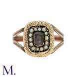 A Pearl And Hairwork Mourning Ring in yellow gold, set with a central glass panel set wit woven