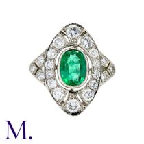 An Emerald and Diamond Ring in platinum, set with a principal oval cut emerald of approximately 1.