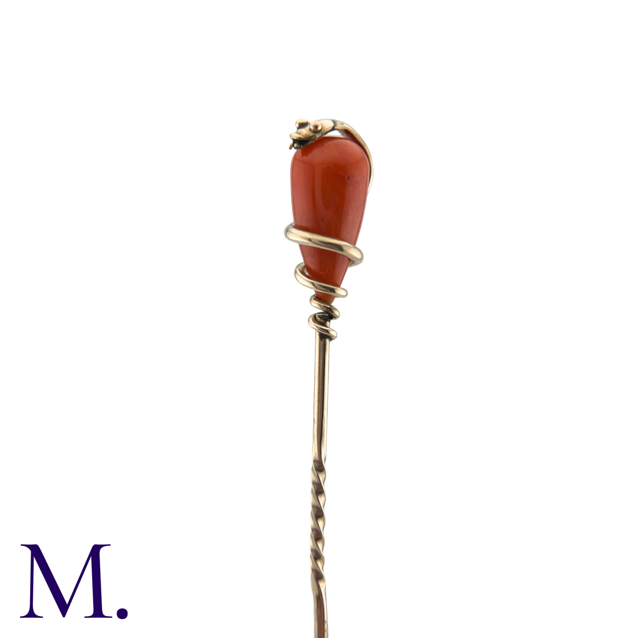A Coral Snake Stick Pin in yellow gold, comprising a polished coral drop encased in a coiled snake