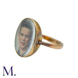 A Portrait Ring in 9k yellow gold, set with a portrait of a young man behind a glass face. Marked