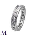 A Diamond Eternity Ring in 18K white gold and platinum, set with round cut diamonds weighing