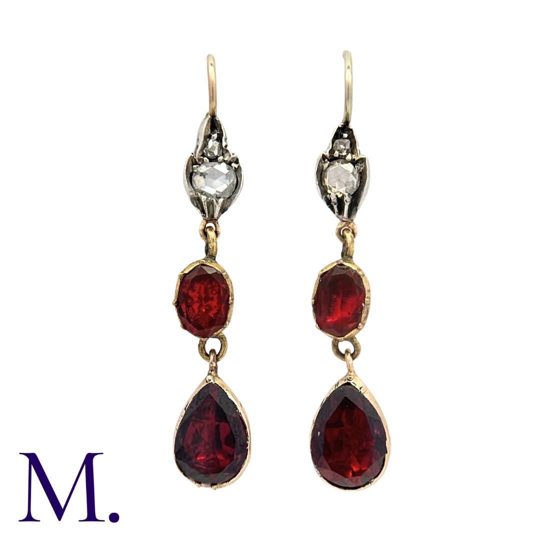 A Pair of Antique Garnet and Diamond Earrings set with flat cut garnets and rose diamonds. Size: 4.