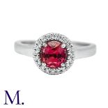 A Padparadscha Sapphire & Diamond Ring in 18K white gold, set with a round cut Padparadscha sapphire